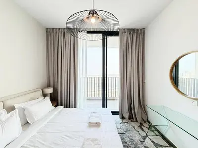 a bedroom with a bed and a large mirror at Belgravia Heights II 1 BHK in JVC Luxury Living in Dubai