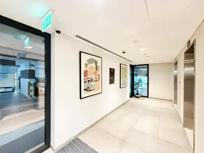 an empty hallway in a building with a window at Belgravia Heights II 1 BHK in JVC Luxury Living in Dubai