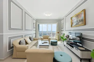 a living room with a couch and a tv at Lake Point Tower 1 BHK by Petals Holiday Homes in Dubai