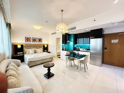 a hotel room with a bed and a kitchen at Capital Bay Studio in Business Bay by Petals Holiday Homes in Dubai