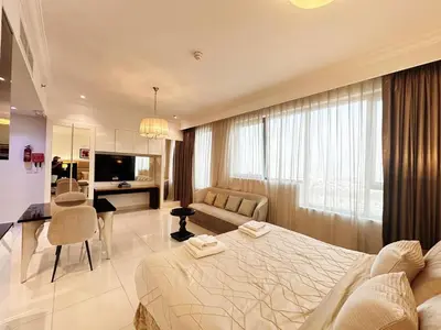 a bedroom with a large bed and a living room at Capital Bay Studio in Business Bay by Petals Holiday Homes in Dubai