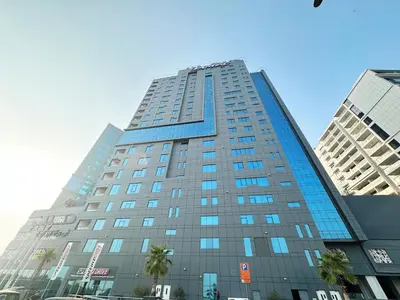 a tall building with blue windows in a city at Capital Bay Studio in Business Bay by Petals Holiday Homes in Dubai