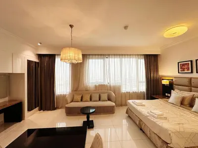 a large bedroom with a bed and a couch at Capital Bay Studio in Business Bay by Petals Holiday Homes in Dubai