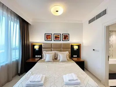 a bedroom with a large bed with two towels on it at Capital Bay Studio in Business Bay by Petals Holiday Homes in Dubai