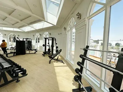 a gym with several treadmills and tread machines at Vincitore Benessere 1BHK in Arjan by Petals Holiday Homes in Dubai