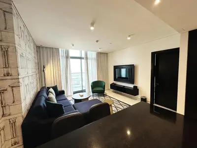 a living room with a couch and a television at Elegant 1BR in Business Bay in Dubai