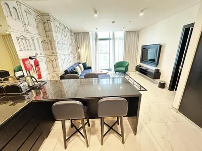 a large living room with a large table and chairs at Elegant 1BR in Business Bay in Dubai