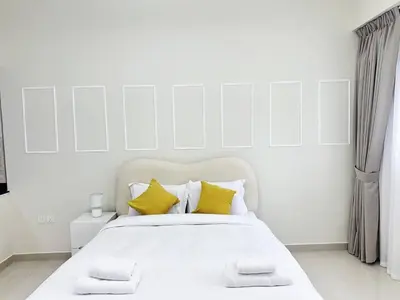 a white bedroom with a large bed with yellow pillows at Profile Residency Studio near Dubai Stadium by Petals Holiday Homes in Dubai