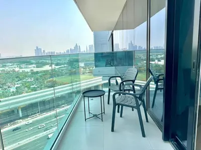 an office with chairs and a desk on a balcony at 1 Residence 1BHK near Metro by Petals Holiday Homes in Dubai