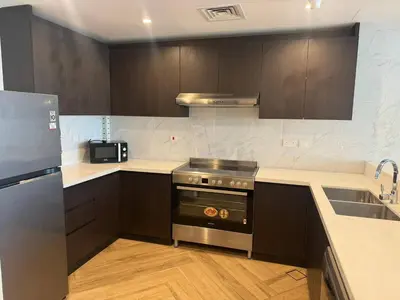 a kitchen with a stove and a sink at 1 Residence 1BHK near Metro by Petals Holiday Homes in Dubai