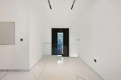 a room with white walls and a black doorway at 5 BR Villa Near Business Bay By Petals Holiday Homes in Dubai
