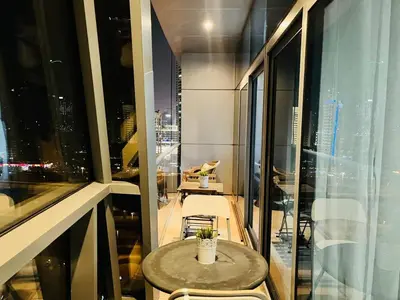 a small table and chairs in a room with a window at Indigo Tower 1 BR in JLT by Petals Holiday Homes in Dubai