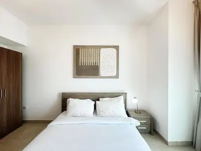 a bedroom with a large white bed with white pillows at preatoni tower 1 BHK in JLT By petals Holiday Homes in Dubai