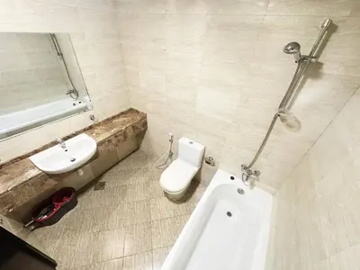 a white bathroom with a sink and a toilet at preatoni tower 1 BHK in JLT By petals Holiday Homes in Dubai