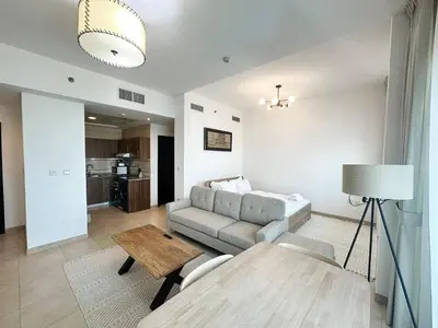 a living room with a couch and a table at preatoni tower 1 BHK in JLT By petals Holiday Homes in Dubai