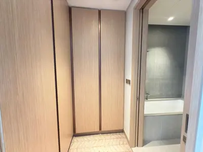 a bathroom with wooden cabinets and a bath tub at Luxurious 2 Bedroom Apt in VDM Residences - Full Burj Khalifa View in Dubai