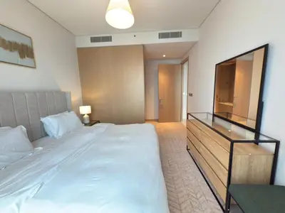 a bedroom with a large bed and a television at Luxurious 2 Bedroom Apt in VDM Residences - Full Burj Khalifa View in Dubai