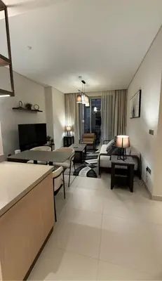a living room with a couch and a table at Luxurious 2 Bedroom Apt in VDM Residences - Full Burj Khalifa View in Dubai