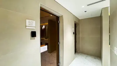 a hallway with a door leading to a bathroom at Modern Std Near Burj Khalifa with Pool and City Views in Dubai