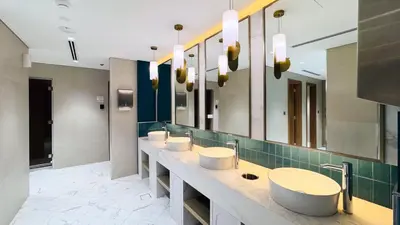 a bathroom with a row of sinks and mirrors at Modern Std Near Burj Khalifa with Pool and City Views in Dubai