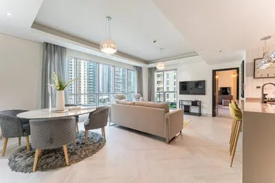 a living room with a table and a couch at HAVN - 2 Bed in The Residences, Burj Khalifa View in Dubai