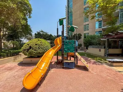 a yellow slide at a playground in a city at HAVN - 2 Bed in The Residences, Burj Khalifa View in Dubai