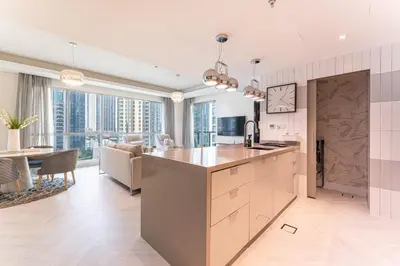 an open kitchen and living room with views of the city at HAVN - 2 Bed in The Residences, Burj Khalifa View in Dubai