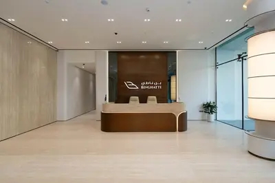 a lobby of a building with a bench in the middle at Binghatti Aurora Soft-Luxe 1BR Abode w Gym & Pool in Dubai