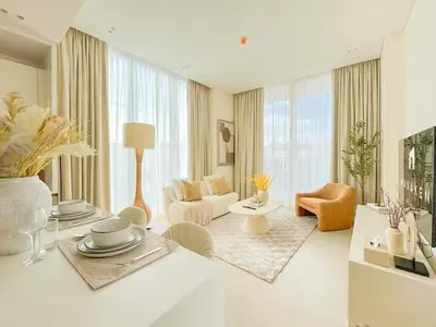a living room with a couch and a table at Binghatti Aurora Soft-Luxe 1BR Abode w Gym & Pool in Dubai
