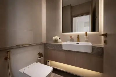 a bathroom with a sink and a toilet and a mirror at Luxury 1BR in JVC Private Balcony Pool & Parking in Dubai