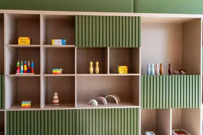 a book shelf with vases and other items on it at Luxury 1BR in JVC Private Balcony Pool & Parking in Dubai