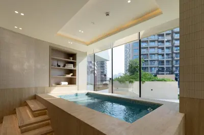 a swimming pool in a room with a large window at Luxury 1BR in JVC Private Balcony Pool & Parking in Dubai