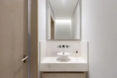 a bathroom with a white sink and a mirror at Luxury 1BR on Palm Jumeirah with Pool Access and Beach in Dubai