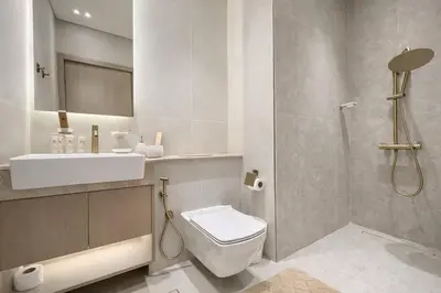 a bathroom with a toilet and a sink and a shower at Urban Oasis 1BR W Private Plunge Pool in Dubai