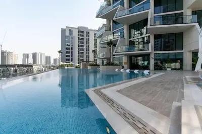 a swimming pool in front of a building at Urban Oasis 1BR W Private Plunge Pool in Dubai