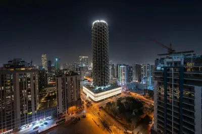 a city skyline at night with a tall building at Urban Oasis 1BR W Private Plunge Pool in Dubai