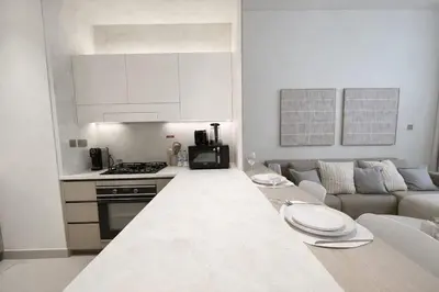 a kitchen and living room with a couch and a table at Urban Oasis 1BR W Private Plunge Pool in Dubai
