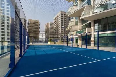 a tennis court in the middle of a building at Stylish Escape 1BR Plunge Pool & Pool View in Dubai