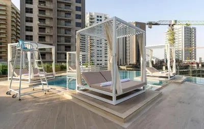 a group of chairs on the roof of a building at Stylish Escape 1BR Plunge Pool & Pool View in Dubai