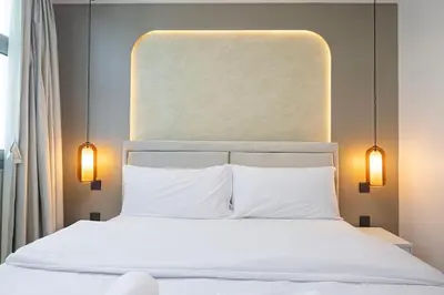 a bedroom with a white bed with two pillows at 3BHK Near Beach High Floor Marina Stay DEC 1203 Tower 1 in Dubai