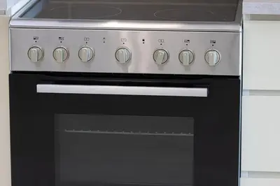 a black oven with a stove top at 3BHK Near Beach High Floor Marina Stay DEC 1203 Tower 1 in Dubai