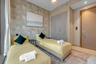 a room with two beds in a room at Waves - Elegant High-Floor 2BR Close To Downtown in Dubai