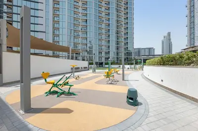 a patio with chairs and tables in a building at Waves - Elegant High-Floor 2BR Close To Downtown in Dubai