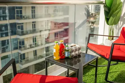 a table with bottles of drinks on a balcony at Stylish 2BHK Central Marina Rooftop Pool DEC T1 601 in Dubai