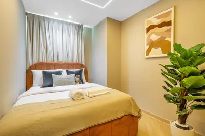 a bedroom with a bed and a potted plant at Luxury 2BHK w Floating Bed in Dubai Marina DEC 1604 in Dubai