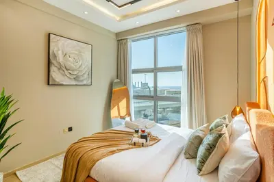 a bedroom with a bed with a large window at Luxury 2BHK w Floating Bed in Dubai Marina DEC 1604 in Dubai