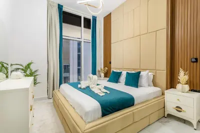 a bedroom with a bed with two stuffed animals on it at Luxury 1 BHK in Al Barsha by Opalz by Danube 1607 in Dubai