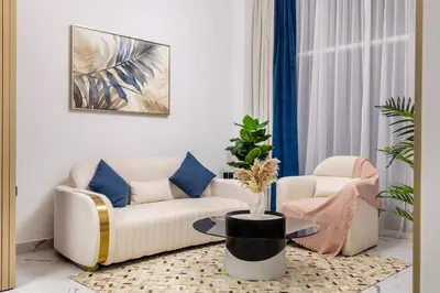 a living room with a couch and a table at Luxury 1 BHK in Al Barsha by Opalz by Danube 1607 in Dubai