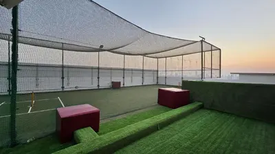 a tennis court with a net on a tennis court at Luxury 1 BHK in Al Barsha by Opalz by Danube 1607 in Dubai