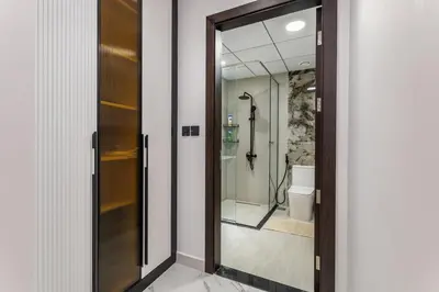 a bathroom with a shower and a glass door at Luxury 1 BHK in Al Barsha by Opalz by Danube 1607 in Dubai